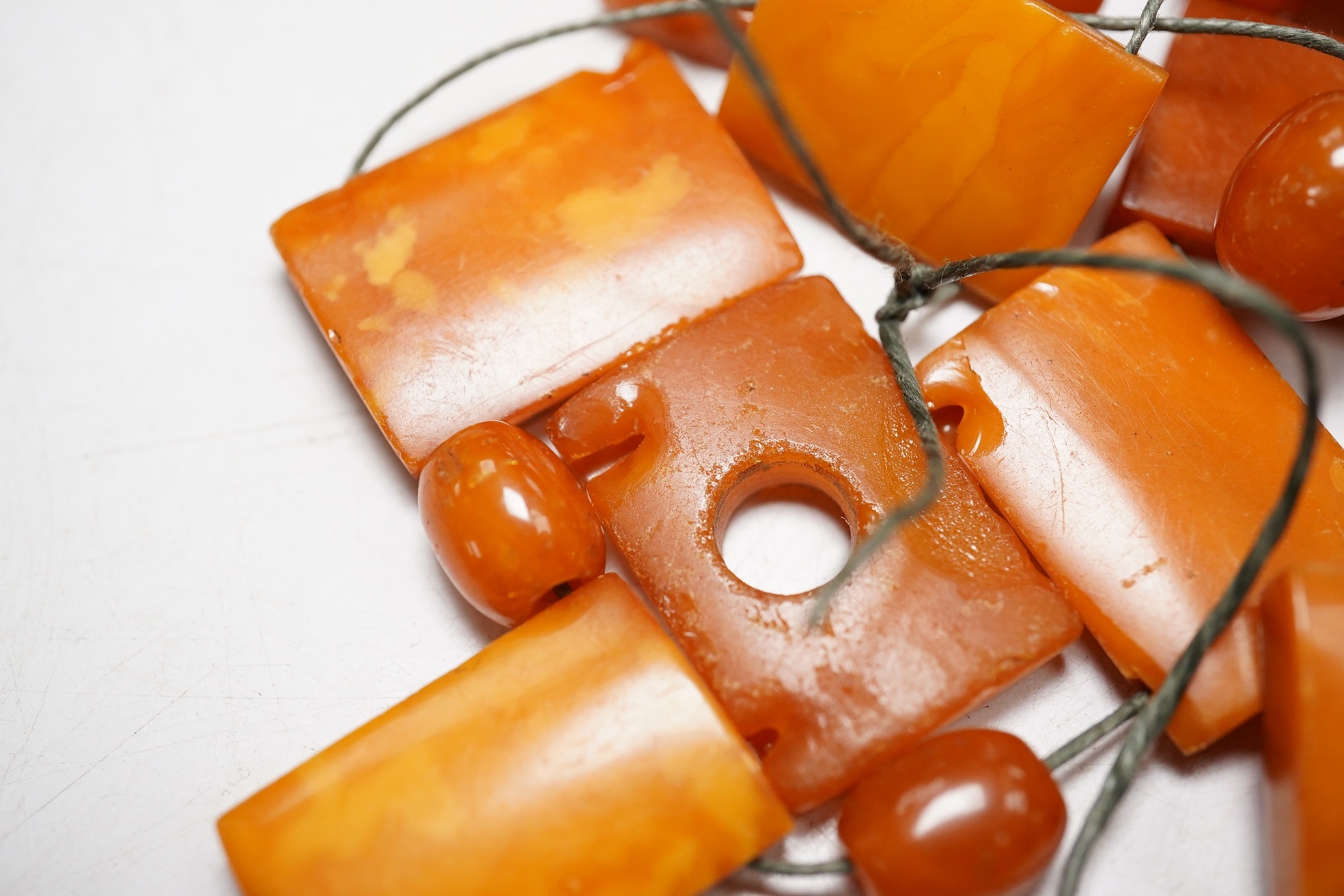 A small group of assorted shaped amber beads, gross weight 26 grams. Condition - poor to fair